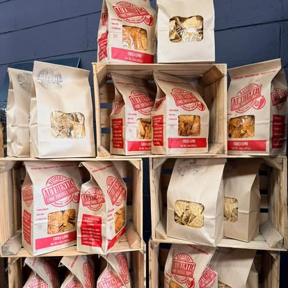 Wooden crates stacked with bags of tortilla chips.