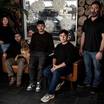 The Gomez family and their dog Chip in the shop.