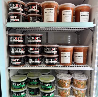 The shop fridge stocked with red salsa, guacamole salsa and pico de gallo.