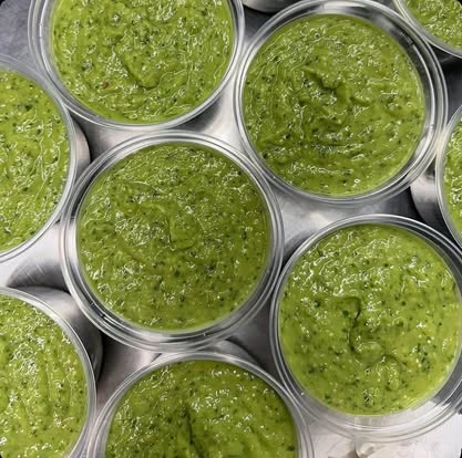 Cups of green guacamole salsa from above.