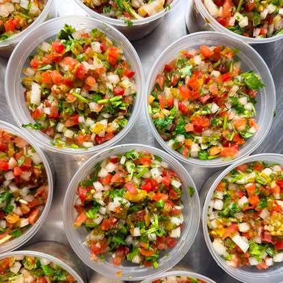 Cups of pico de gallo with tomato, onion and cilantro.