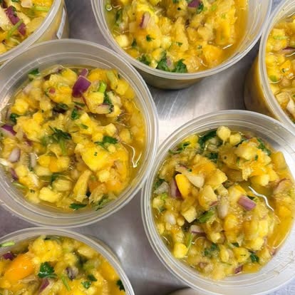 Cups of pineapple mango salsa with red onion and cilantro.